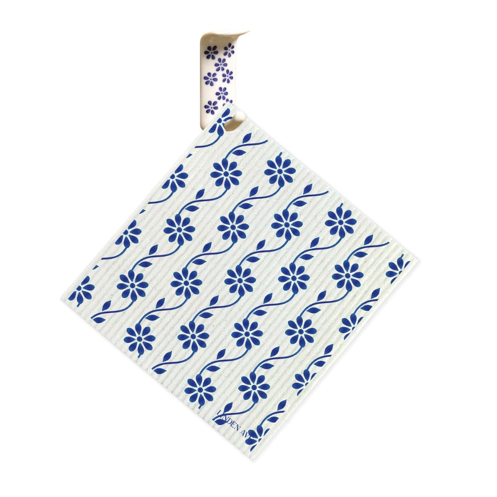 Blue floral Linden Ave Swedish dishcloth hanging on matching ceramic hook from Marigold Manor Set