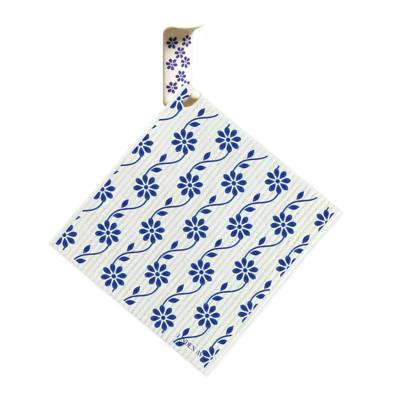 Blue floral Linden Ave Swedish dishcloth hanging on matching ceramic hook from Marigold Manor Set